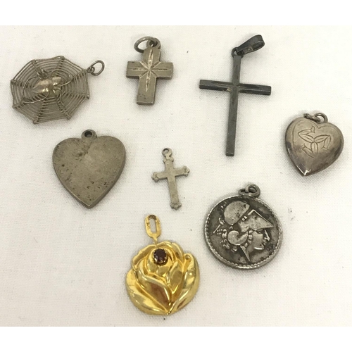 1022 - 8 vintage silver and white metal pendants. Comprising: 3 crosses, 2 heart shaped, St Christopher sty... 