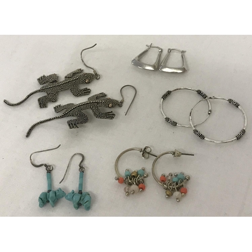 1023 - 5 pairs of silver and white metal earrings in hoop and drop styles. To include a pair of bear shaped... 