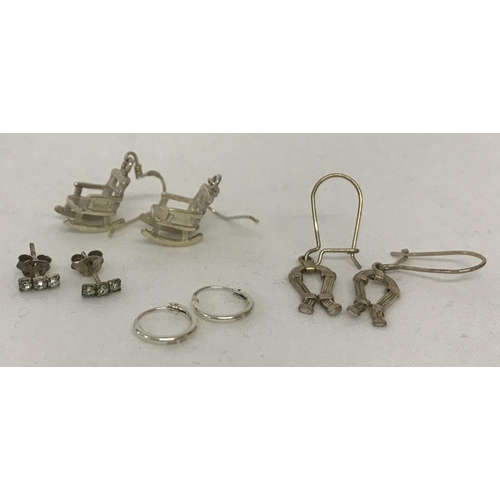 1025 - 4 pairs of silver and white metal earrings in drop, hoop and stud styles. To include a paid of rocki... 