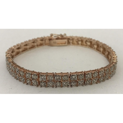 1030 - A silver dress bracelet set with 106 small diamonds. Rose gold tone overlay. Diamonds set in square ... 