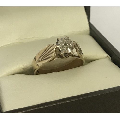 1033 - A vintage 9ct gold, illusion set diamond dress ring. Pattern to both shoulders. Single small diamond... 