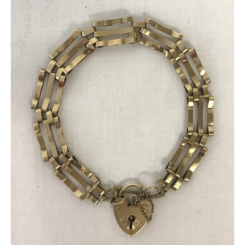 1045 - A 9ct gold 3 bar bracelet with padlock and safety chain.  Total weight approx.6.9g.