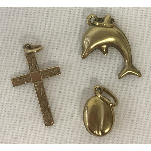 1047 - 3 vintage 9ct gold pendants. A cross with floral decoration to front. Together with a dolphin and a ... 