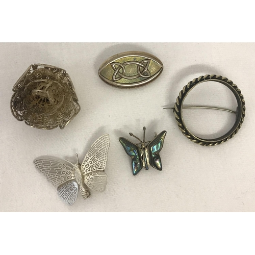 1052 - 5 silver and white metal vintage brooches. To include butterfly and Celtic design.