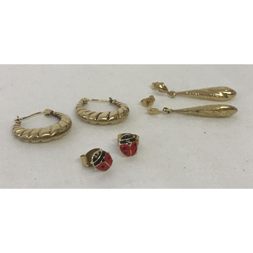 1064 - 3 pairs of 9ct gold earrings in both drop and stud styles. Comprising: A pair of hoops with twist de... 