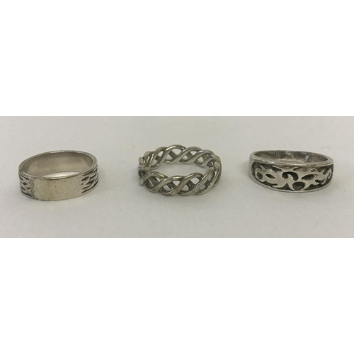 1121 - 3 men's silver band style rings; 2 with Celtic designs and the other with oriental detail.  Sizes Z,... 