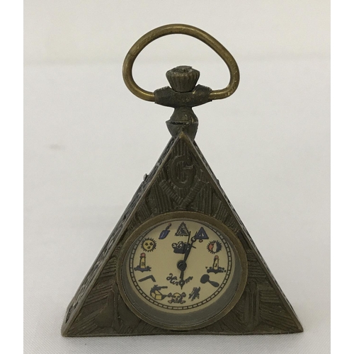 1172 - A small brass cased, triangular shaped pocket watch with Masonic style decoration.  Approx. 6.5cm x ... 