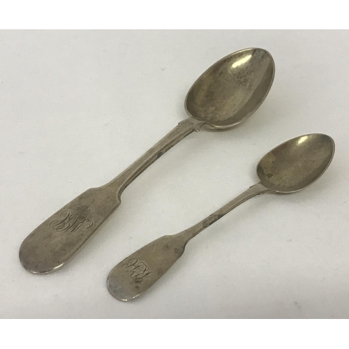 1182 - A Victorian silver fiddleback table spoon Hallmarked Thomas Hart Stone, Exeter 1867. Together with a... 