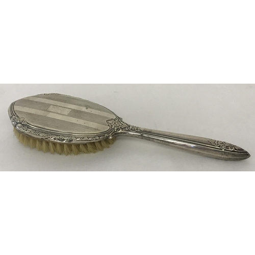 1195 - A vintage sterling silver backed decorative ladies hair brush. With engine turned detail and rectang... 