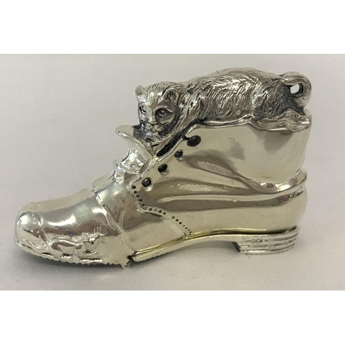 1209 - A white metal novelty vesta case in the shape of a boot, marked 