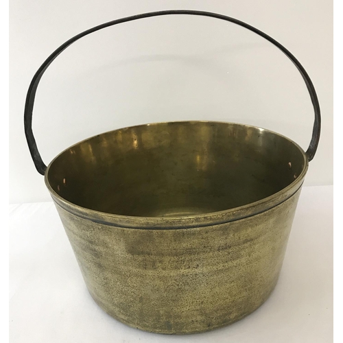 1263 - A heavy antique brass, fixed riveted handle cooking pan.  Approx. 37.5cm tall x 35cm diameter.