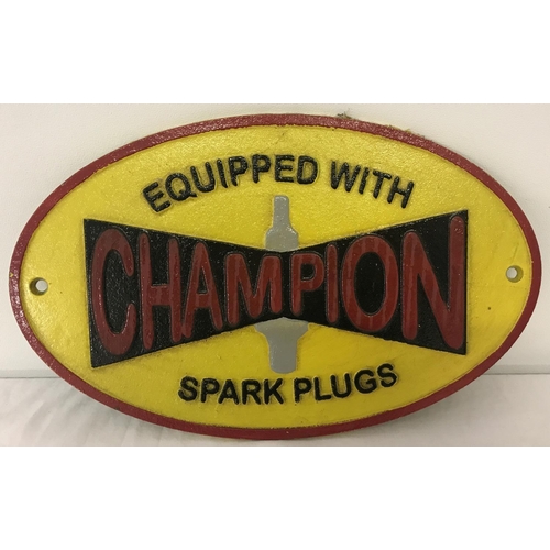 1359 - A painted cast iron Champion spark plugs, oval shaped wall hanging plaque. With fixing holes. Approx... 