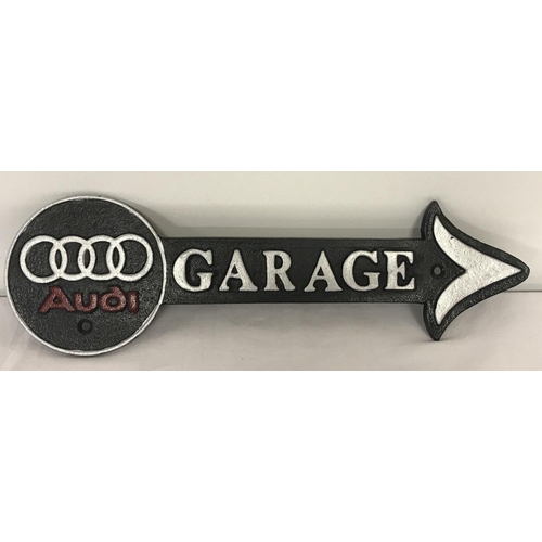 1362 - A black, silver and red painted Audi Garage arrow wall hanging sign.  Approx. 41cm long.