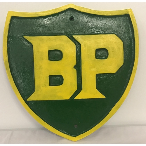 1364 - A large green and yellow painted cast iron BP wall hanging plaque.  Approx. 34cm x 31cm.