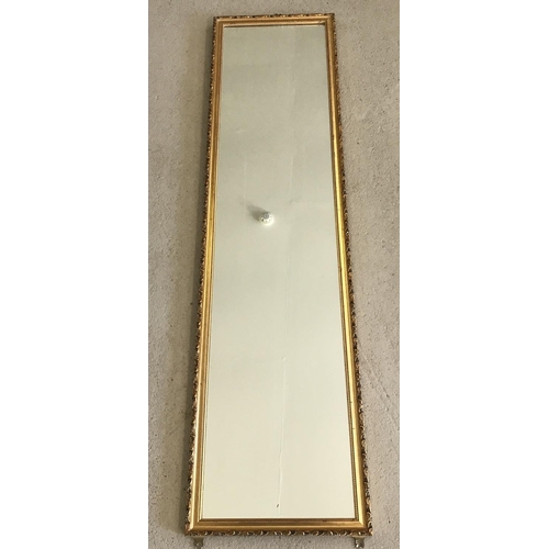 1503 - A gilt framed wall hanging mirror.  Frame size approx. 116.5 x 31 cm.