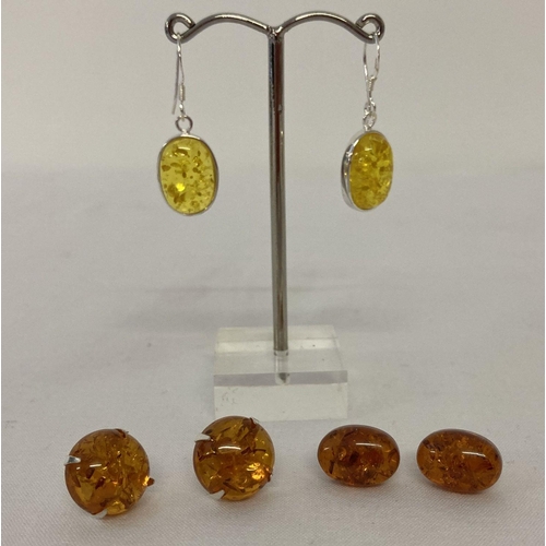 1009 - 3 pairs of amber earrings; 2 pairs of studs together with a pair of yellow amber drop earrings.