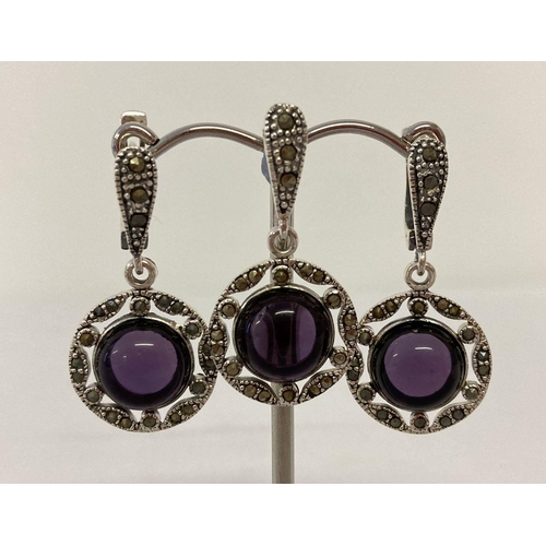 1036 - A silver and amethyst pendant and matching earrings set with marcasite's. Marked 925 to reverse. App... 