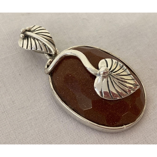 1040 - A silver and goldstone Art Nouveau style oval shaped pendant, with leaf shaped bale. Marked 925. App... 