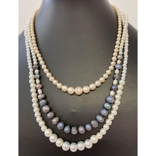 1066 - A freshwater and faux pearl necklace with 9ct gold clasp. Together with 2 faux pearl necklaces with ... 