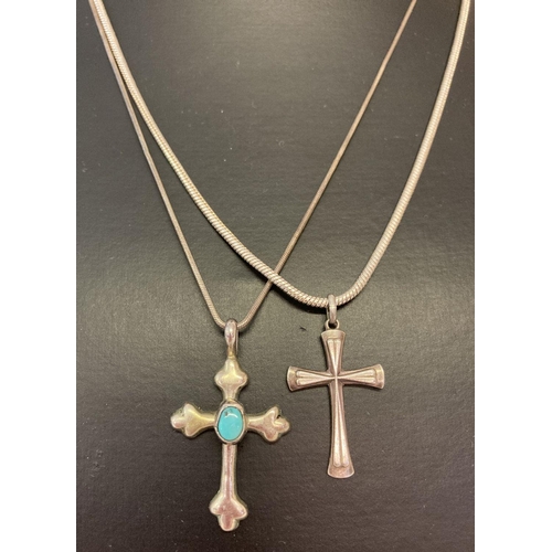 1075 - 2 silver cross shaped pendants on chains. A sterling silver turquoise set cross, with makers mark to... 