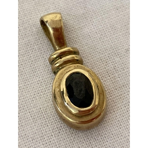 1076 - An oval shaped 9ct gold pendant set with central sapphire. Pendant approx. 2cm, total length. Visibl... 