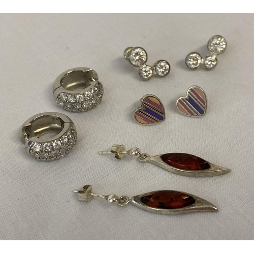 1081 - 4 pairs of silver earrings in stud and drop styles. To include amber set drops and clear stone set h... 