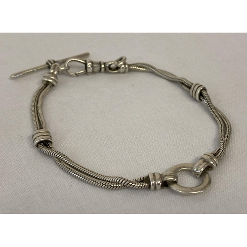 1086 - A decorative silver rope chain bracelet with ring detail. Lobster style claps with t bar. Clasp mark... 