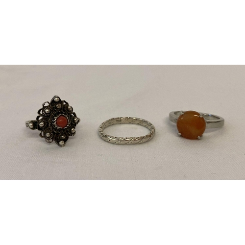 1097 - 3 silver and white metal dress rings. An orange jade solitaire and a twist design band. Together wit... 