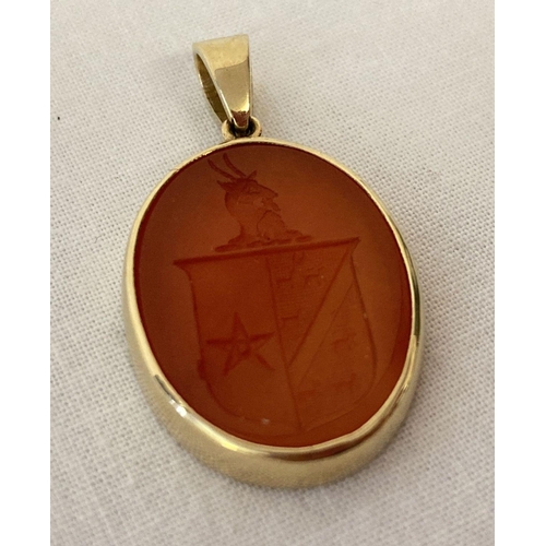 1101 - A carved oval carnelian pendant depicting a coat of arms in a 9ct gold mount. Mount fully hallmarked... 