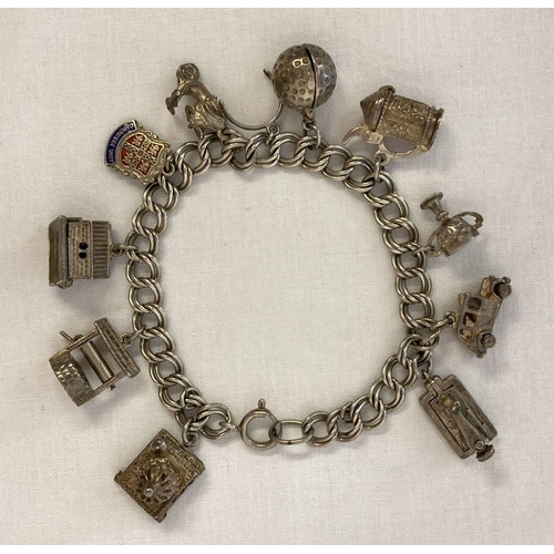 1103 - A vintage white metal charm bracelet with 11 silver and white metal charms. 5 charms open to reveal ... 