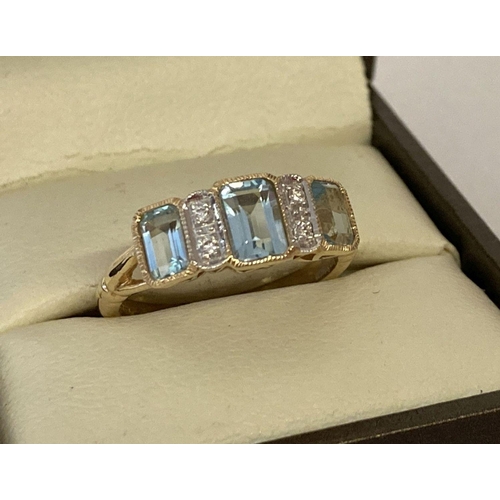 1105 - A 9ct gold blue topaz and diamond set dress ring by Luke Stockley, London. 3 baguette cut blue topaz... 