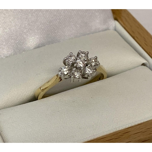 1109 - A 18ct gold and diamond set flower head design dress ring. 7 round cut diamonds totalling .35ct. Ful... 