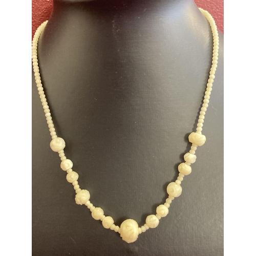 1114 - A vintage graduating carved bone bead necklace with screw clasp.  Approx. 16 inches long.