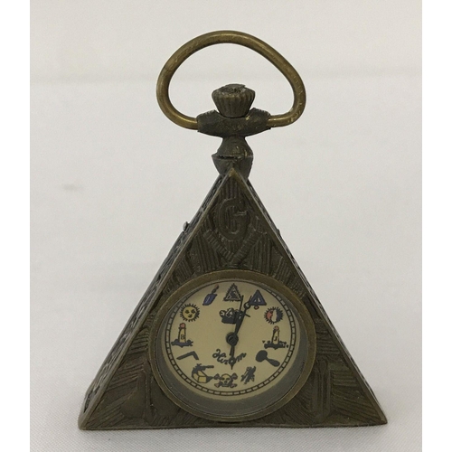 1119 - A small brass cased, triangular shaped pocket watch with Masonic style decoration.  Approx. 6.5cm x ... 