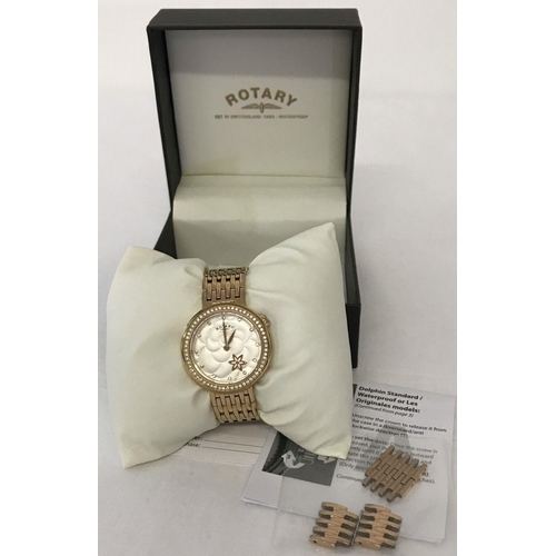 1120 - A ladies modern wristwatch by Rotary. Cushion style satin finish white face with gold tone flower. G... 