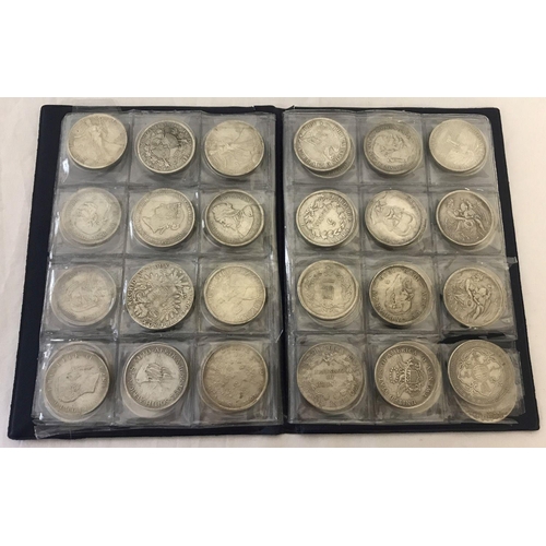 1158 - A folder containing 70 assorted white metal coins from around the world.  Folder approx. 21cm x 16cm... 