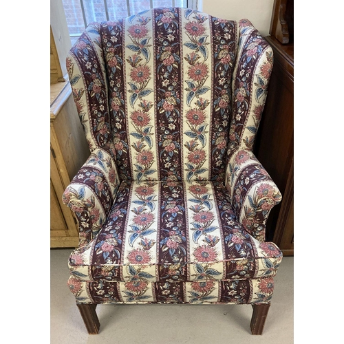 1610 - A vintage wooden framed wing back armchair with floral and maroon striped upholstery.