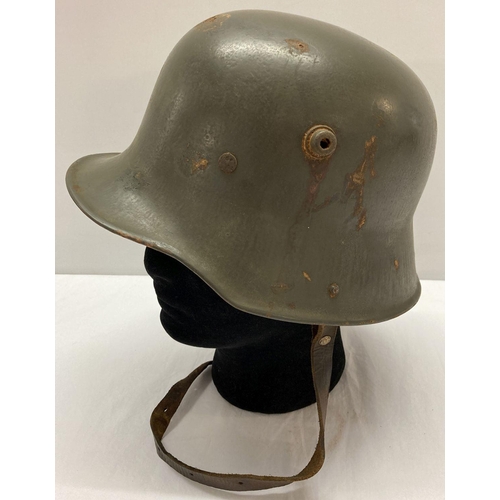 117 - A WWI style Austrian M17 helmet with liner and chin strap.