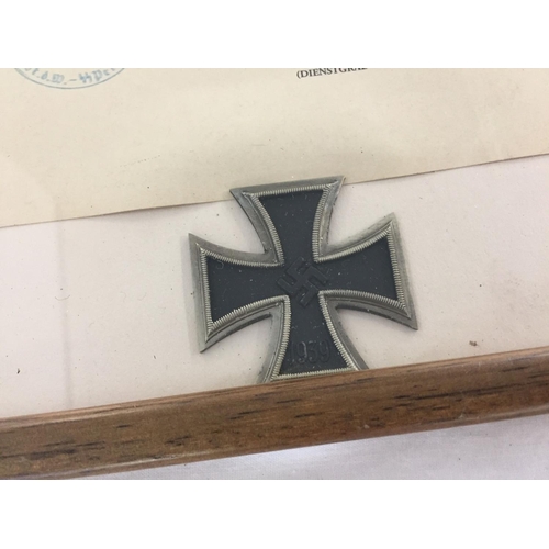 380 - A WWII style framed and glazed Waffen SS Iron Cross first class EK1 and award certificate.  Frame si... 