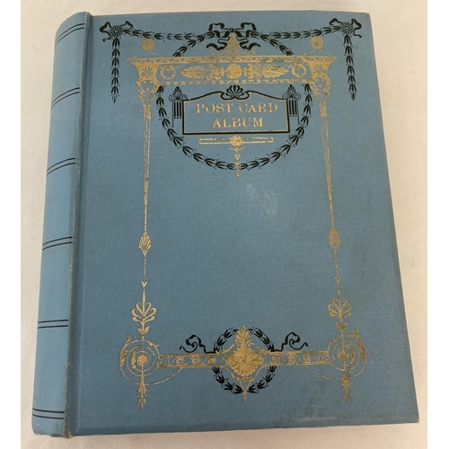 162 - A vintage blue Art Nouveau postcard album containing a quantity of cards. To include: greetings card... 