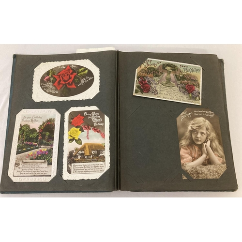 172 - A vintage album containing a collection of 148 antique and vintage greetings cards and postcards. To... 