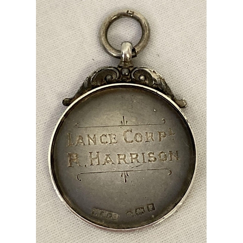 207 - An antique silver watch fob/medallion engraved 