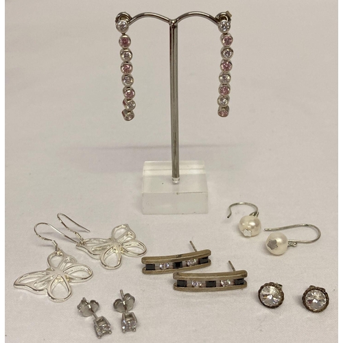 29 - 6 pairs of silver and white metal earrings in drop and stud styles.  To include: butterfly drops, cl... 