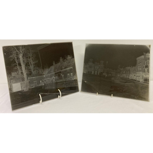 431 - 2 large sized Victorian/Edwardian glass plate negatives.  One featuring a town square scene, showing... 