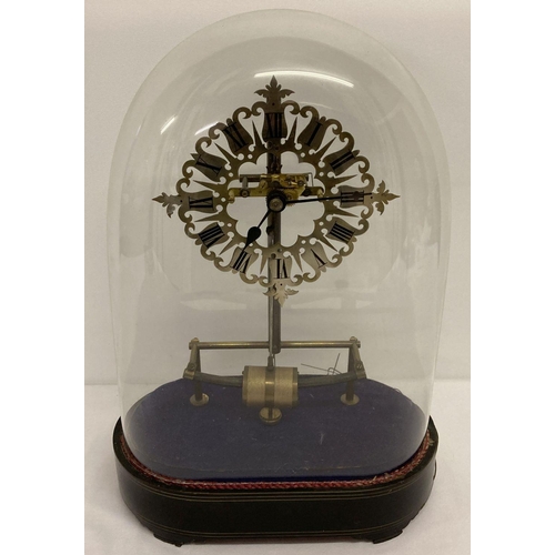 442 - An antique Bulle electric clock with ornate brass skeleton frame and oval shaped glass dome.  On a d... 