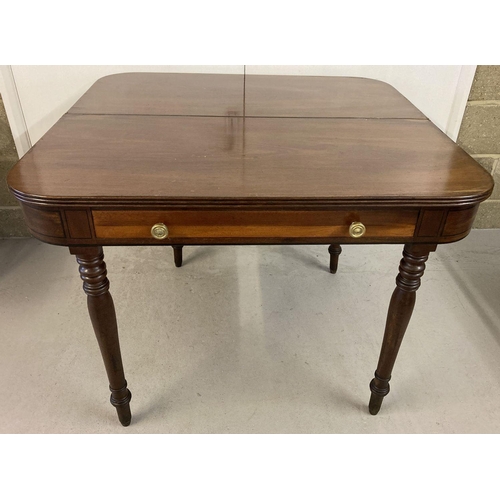 445 - A Georgian mahogany fold out breakfast table with turned legs and dummy drawer.   Approx. 76 x 101cm... 