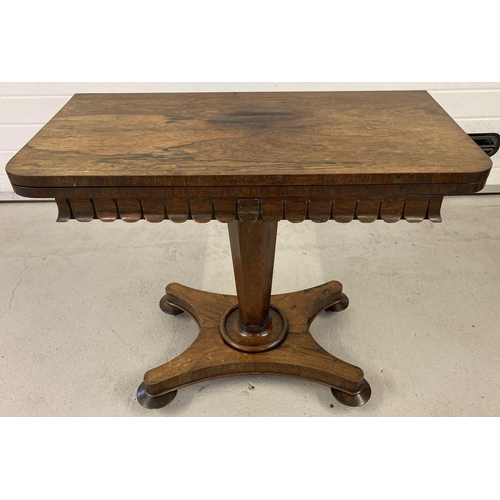 454 - A Victorian walnut veneer games table with swivel and fold out top and fringed decoration.  Swivel t... 