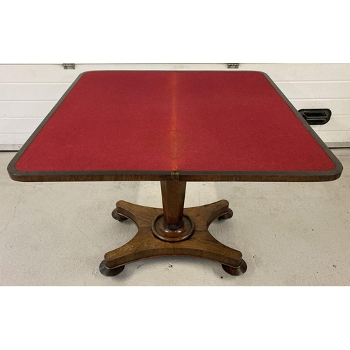 454 - A Victorian walnut veneer games table with swivel and fold out top and fringed decoration.  Swivel t... 