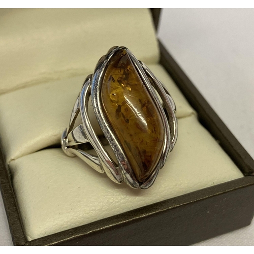 1072 - A modern wave design silver ring set with amber, back of mount marked 925.   Ring size Q.