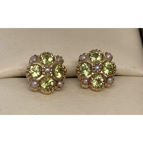 1080 - A pair of 9ct gold stud style earring set with Peridots and seed pearls by Luke Stockley, London.  H... 